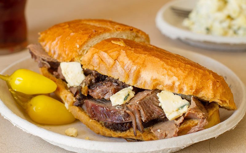 Philippe the Original signature dishes French Dip Sandwich (beef, lamb, pork, or turkey), Coleslaw, Potato Salad, Pickled Eggs, 10-cent coffee.